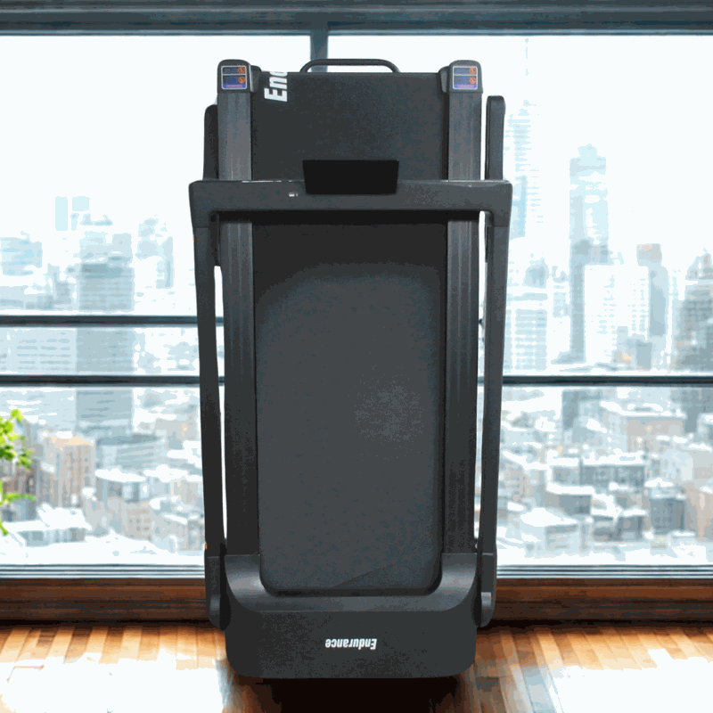 Foldable Endurance Athlete Treadmill in modern apartment with city skyline view.